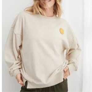 AERIE COZY CREWNECK DISTRESSED SMILEY FACE CREAM OVERSIZED